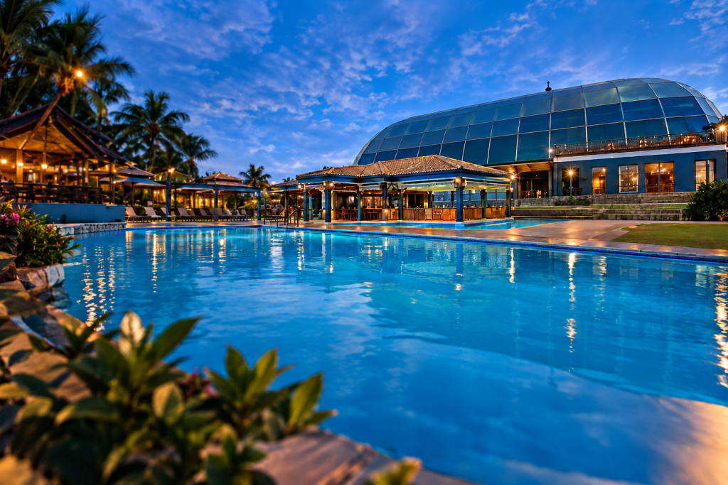 Ebukhosini Resort pool and glass-domed building at dusk